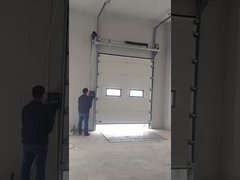 Dock leveler and sectional door