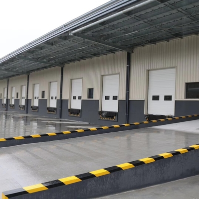 Sectional doors open vertically and are suspended under the ceiling, that the space outside and inside can be utilised